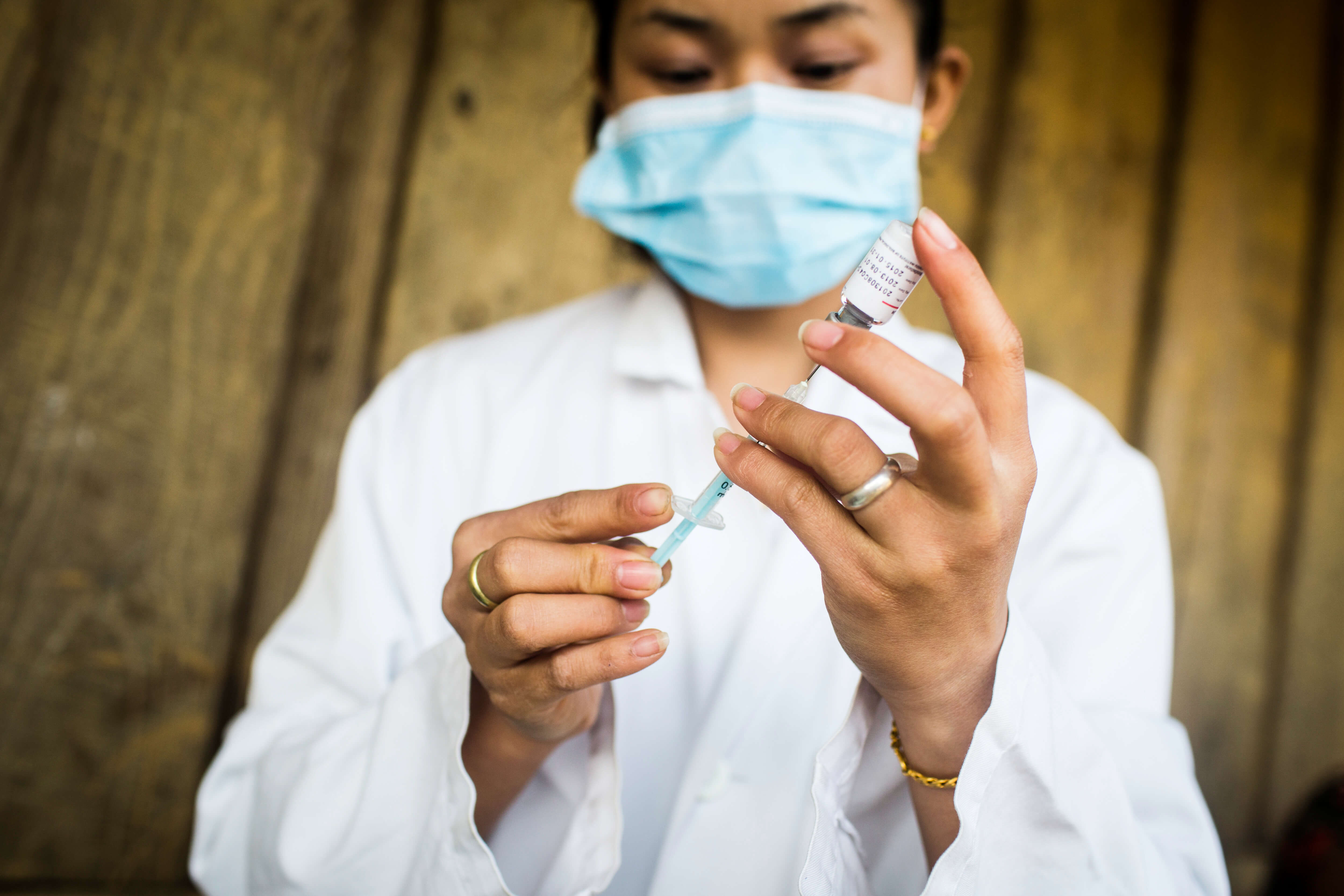 A healthworker in Laos prepares a vaccine. PATH/Aaron Joel Santos
