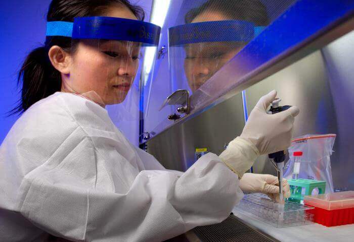 A CDC researcher works with an HIV sample to extract DNA. Photos: CDC/James Gathany.