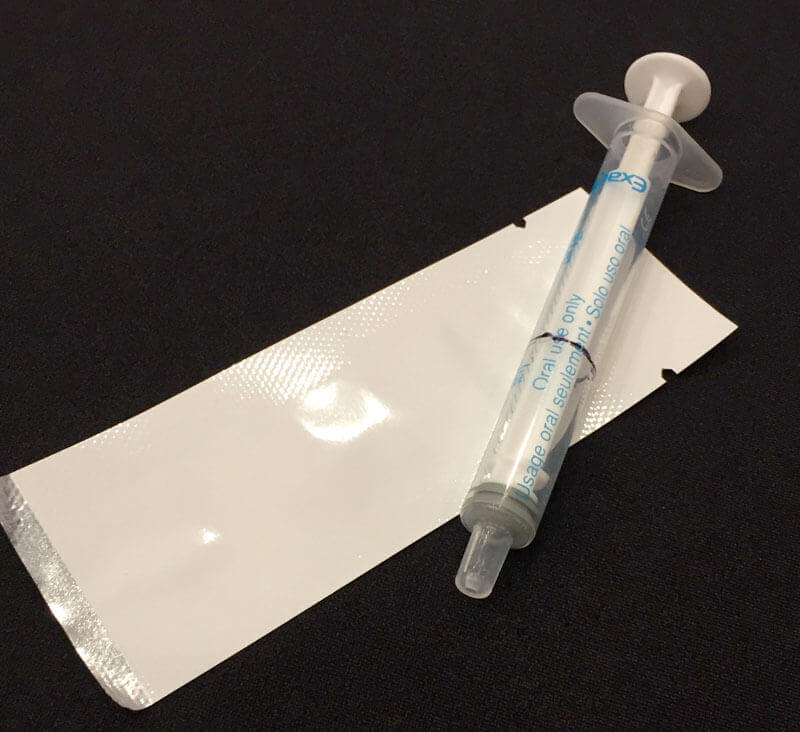 A syringe typically used to measure ARV dosage and the Pratt Pouch which could replace it. Photo: Marissa Chmiola/GHTC